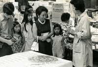 Senior Work Center, Item 11, front: Pauline Yoshioka, Work Center manager (far right), talks about the center with visitors, including Ichiro Kagei (fifthfrom left)