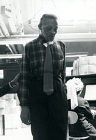 Blood Assurance, Communal Living, Issei Work Center, Body Dynamics, Annual Community Picnic, and Market Day, Item 28: Easter Parade participants made hats and ties from materials available in the work center. This man models the tie he made