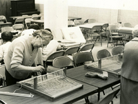 Weaving, Item 2, front: Mrs. Monma works at her loom