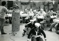 New Year's Party, Item 15, front: Skit performers (L to R) Mike Ishii (at microphone), Cecilia Ishibashi (in chimney), mental health supervisor Dennis (last name unknown), office secretary Kathy Harano, and unidentified mental health counselor