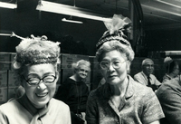 Blood Assurance, Communal Living, Issei Work Center, Body Dynamics, Annual Community Picnic, and Market Day, Item 17, front: Mrs. Mayeda and Mrs. Kimura model their Easter Parade hats. Participants made hats from materials available in the work center.