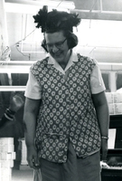 Blood Assurance, Communal Living, Issei Work Center, Body Dynamics, Annual Community Picnic, and Market Day, Item 30: Easter Parade participants made hats and ties from materials available in the work center. This woman models her bonnet