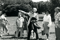 Annual [Community] Picnic and Workshop [Senior Work Center], Item 8, front: Mrs. Sato (left foreground) and Mr. Besho (center foreground, arm raised)