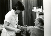 Blood Assurance, Communal Living, Issei Work Center, Body Dynamics, Annual Community Picnic, and Market Day, Item 2, front: Mr. Nishimura, work center client, has his blood pressure checked