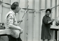 New Year's Party, Item 14, front: Mrs. Monma with broom (left)