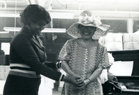 Blood Assurance, Communal Living, Issei Work Center, Body Dynamics, Annual Community Picnic, and Market Day, Item 32: Easter Parade participants made hats and ties from materials available in the work center. The woman at right models her creation