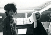 Blood Assurance, Communal Living, Issei Work Center, Body Dynamics, Annual Community Picnic, and Market Day, Item 23, front: Easter Parade participants made hats and ties from materials available in the work center. Mrs. Eiko Fricke (left) and Mary Fukui