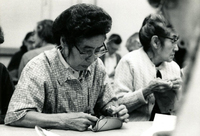 Leather Craft, Item 1, front: Mrs. Nakao (left) and Mrs. Karakomi (right) participate in the leather craft program