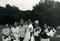 Annual [Community] Picnic and Workshop [Senior Work Center], Item 1, front: Social worker Ichiro Kagei (third from right) models tissue "dress" created by Issei. Mrs. Mayeda (second from right) stands next to him